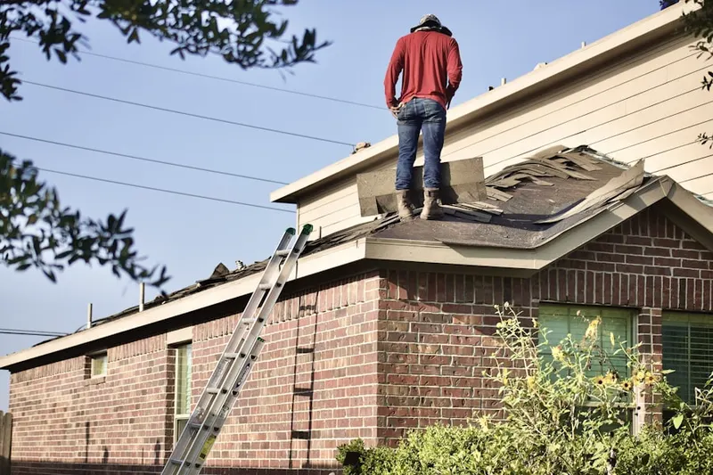Professional roofer working on a residential roof in Downtown Riverside